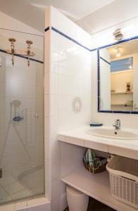 a bathroom with a sink and a shower at Les Hauts de Pavellone in Porto-Vecchio