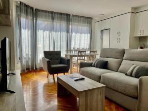 a living room with a couch and a table at Cíes Premium Suitel García Barbón 73 - Love your Stay in Vigo