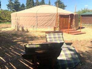 a yurt with a chair and a grill in front at Distinctive tiny house in Sarrians with terrace in Sarrians
