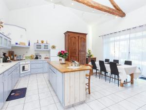 a kitchen and dining room with a table and chairs at Family Stay in Scenic Cazals in Cazals +32 photos