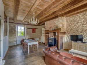 a living room with a couch and a table at Alluring Holiday Home in D gagnac with Heated Pool in Dégagnac