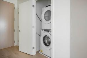 a washer and dryer in a laundry room at Blueground South Boston gym near T shops BOS-1024 in Boston