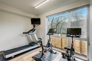 a gym with two exercise bikes and a window at Blueground Capitol Hill gym bbq patio SEA-725 in Seattle