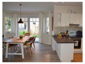 a kitchen and dining room with a table and chairs at Holiday home Wiedblick in Neu Gaarz