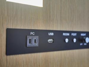 a close up of a remote control in an elevator at Kansai Airport Washington Hotel in Izumi-Sano