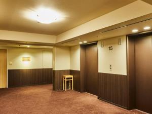 a hallway with doors and a stool in a building at Kansai Airport Washington Hotel in Izumi-Sano