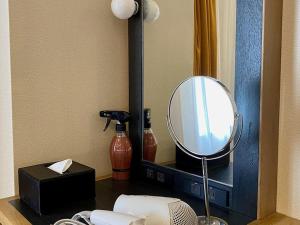 a mirror sitting on top of a table in a room at Kansai Airport Washington Hotel in Izumi-Sano