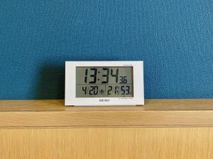a clock sitting on top of a wooden shelf at Kansai Airport Washington Hotel in Izumi-Sano