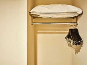 a towel rack with a bed in a room at Kansai Airport Washington Hotel in Izumi-Sano