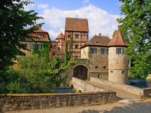 an old castle with a bridge and a building at Holiday home gardener's house in Unsleben