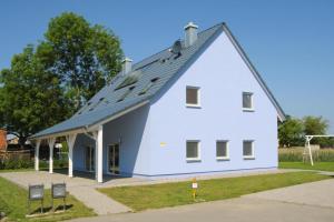 a white house with a gambrel roof at Semi detached houses Hyggelig Seehausen in Seehausen