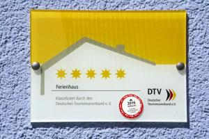 a yellow sign with four yellow stars on it at Semi detached houses Hyggelig Seehausen in Seehausen
