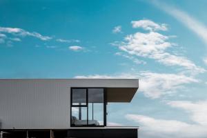 a building with a window and a cloudy sky at Sky Pod 1 - Luxury Off-Grid Eco Accommodation in Cape Otway