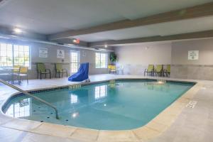 a large swimming pool in a room with tables and chairs at Holiday Inn Express Jackson by IHG in Jackson