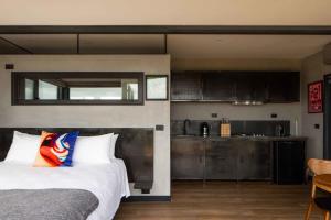 a bedroom with a bed and a kitchen at SKY SHIP 2 Luxury Off-Grid Eco Accommodation in Cape Otway