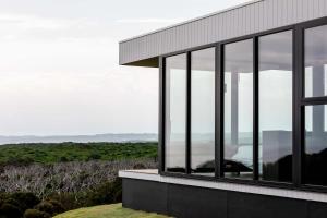 a glass house with a view of the ocean at Sky Pod 2 - Luxury Off-Grid Eco Accomodation in Cape Otway