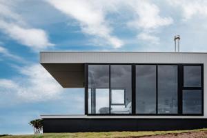 a house with large windows on top of a hill at Sky Pod 2 - Luxury Off-Grid Eco Accomodation in Cape Otway