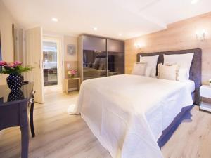 a bedroom with a large white bed and a room at Holiday apartment Family Lodge in Wernigerode
