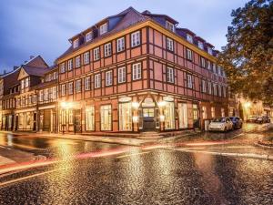 a large brown building on a city street at night at Holiday apartment Family Lodge in Wernigerode