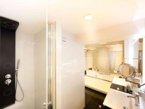 a bathroom with a shower and a sink and a mirror at Holiday apartment Family Lodge in Wernigerode +13 photos