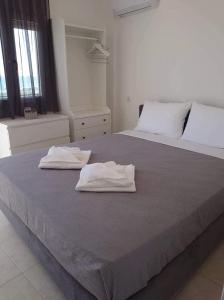 Postel nebo postele na pokoji v ubytování Akrotiri rooms + 10 fotografií