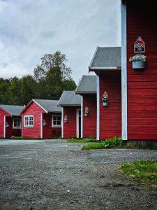 a row of red barns with flowers in the window at Tromsø Lodge & Camping in Tromsø +32 photos