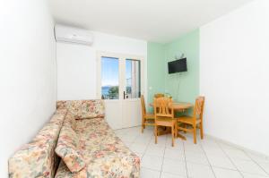 a living room with a couch and a table at Apartments Laguna in Stomorska