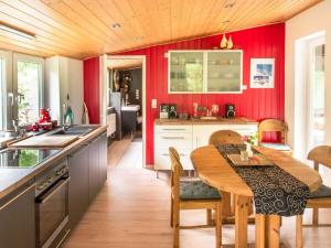 a kitchen with a wooden table and red walls at Romantic apartment with balcony 