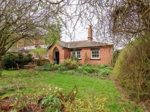 a brick house with a yard in front of it at Bousdale Cottage in Guisborough