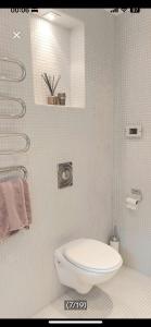a white bathroom with a toilet and a sink at Casa dolce Casa apartment Oslo in Oslo