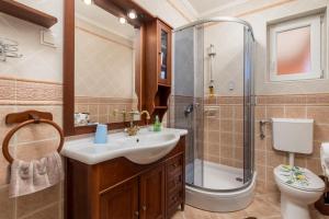 een badkamer met een douche, een wastafel en een toilet bij Villa Monticello Crikvenica, 200m from sea with rome garden in Dramalj