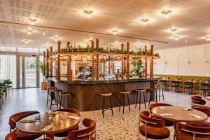 a restaurant with tables and chairs and a bar at Crowne Plaza Lyon - Cité Internationale in Lyon