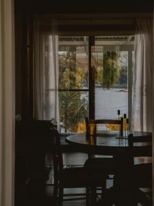 a table and chairs in a room with a window at Sunken Sea Shack - waterfront getaway in Eggs and Bacon Bay +13 photos