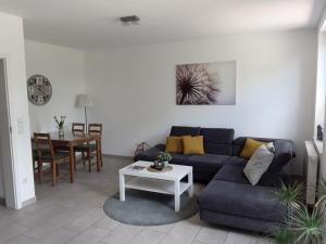 a living room with a couch and a table at Pleasant apartment in Ostbevern in Ostbevern