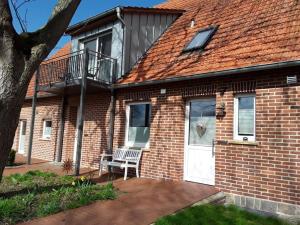a brick house with a white door and a balcony at Pleasant apartment in Ostbevern in Ostbevern