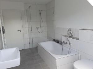 a bathroom with a tub and a shower and a toilet at Pleasant apartment in Ostbevern in Ostbevern