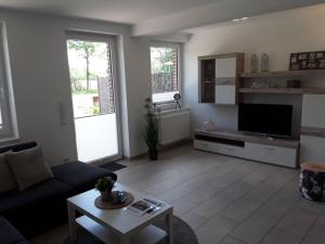 a living room with a couch and a tv at Pleasant apartment in Ostbevern in Ostbevern +14 photos