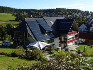 a house with solar panels on top of it at Holiday apartment Kieschtock in Unterkirnach