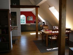 a kitchen and dining room with a table in a attic at Holiday apartment Old Warehouse in Münster