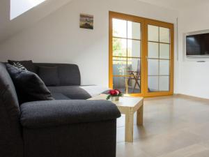 a living room with a couch and a table at Holiday apartment Thoma in Königheim