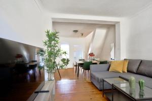 a living room with a couch and a table at Delightful 2 Bedroom House Pyrmont 2 E-Bikes Included in Sydney