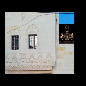 a building with two windows and a sign on it at KING SOLOMON PALACE in Avanos
