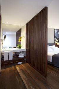 a bedroom with a bed and a sink and a mirror at Hotel Estelar Parque de la 93 in Bogotá
