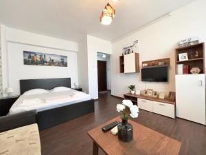 een slaapkamer met een groot bed en een salontafel bij Mercur Home in Ploieşti