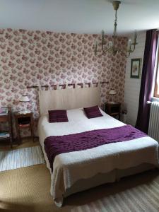 a bedroom with a large bed with purple sheets at DUCK HOUSE in Saint-Wandrille-Rançon