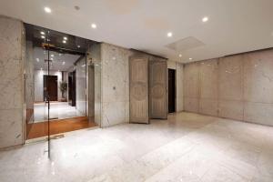an empty room with glass doors and marble walls at Elegant studio avenue Montaigne in Paris