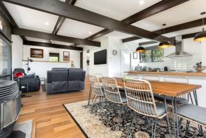 a living room with a wooden table and chairs at Mudbrick house in Gembrook