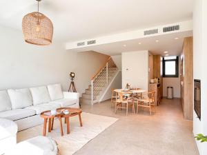 a living room with a white couch and a table at Tarifa Cozy House - La Tramontana in Tarifa