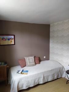 a bedroom with a bed with two books on it at DUCK HOUSE in Saint-Wandrille-Rançon