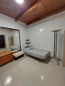 a room with a mirror and a bed and a tv at Lanzarote Hostel in Arrecife